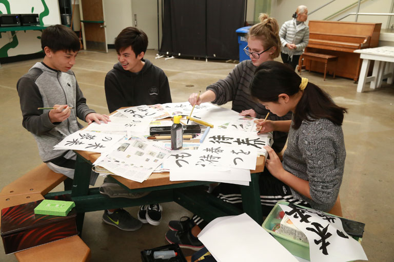 students practicing calligraphy
